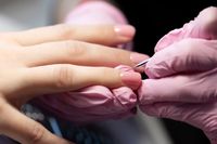 manicurist-doing-gel-nail-design-for-client-close-up