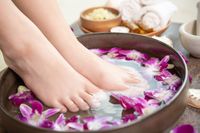 spa-treatment-and-product-for-female-feet-and-hand-spa-orchid-flowers-in-ceramic-bowl